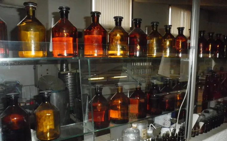 Amber glass bottles on shelves in a perfumer’s workshop